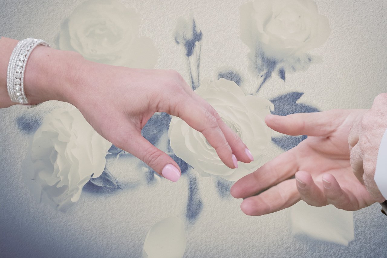 Hands Reaching toward each other with White Rose background