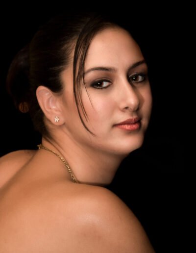 Young Woman Portrait looking over bare shoulder